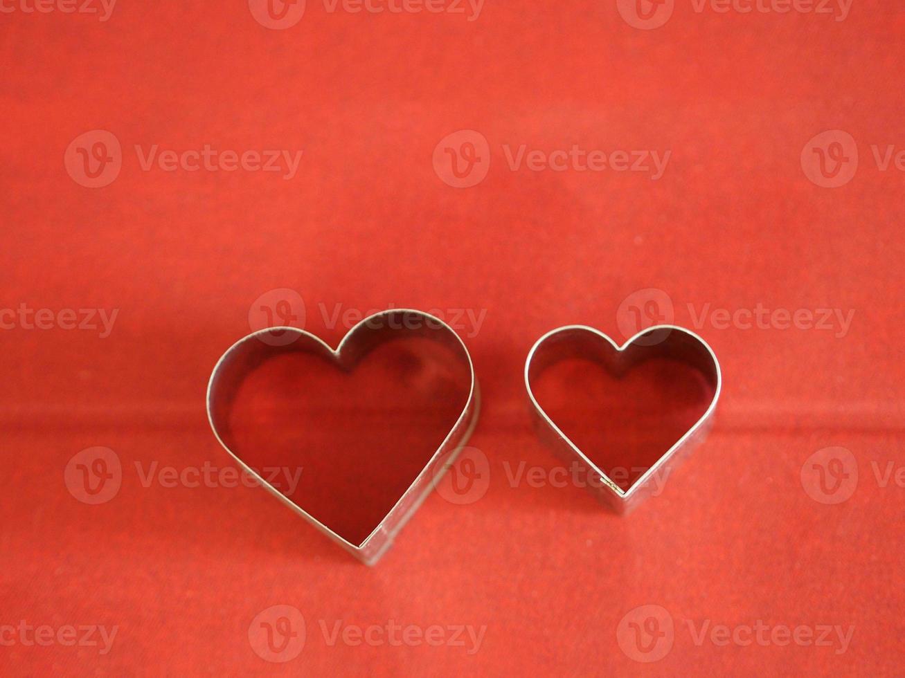 bread molds stainless Heart shaped on red background, love Valentine Day for copy text card, background photo