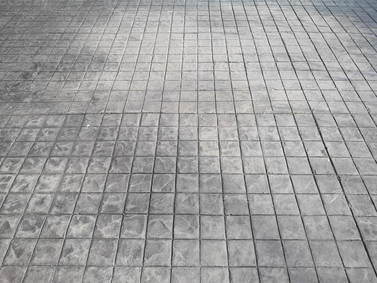 Stamp concrete black grey color hardener printing patterns on the cement or mortar surface block shape Square pattern material rough texture background photo