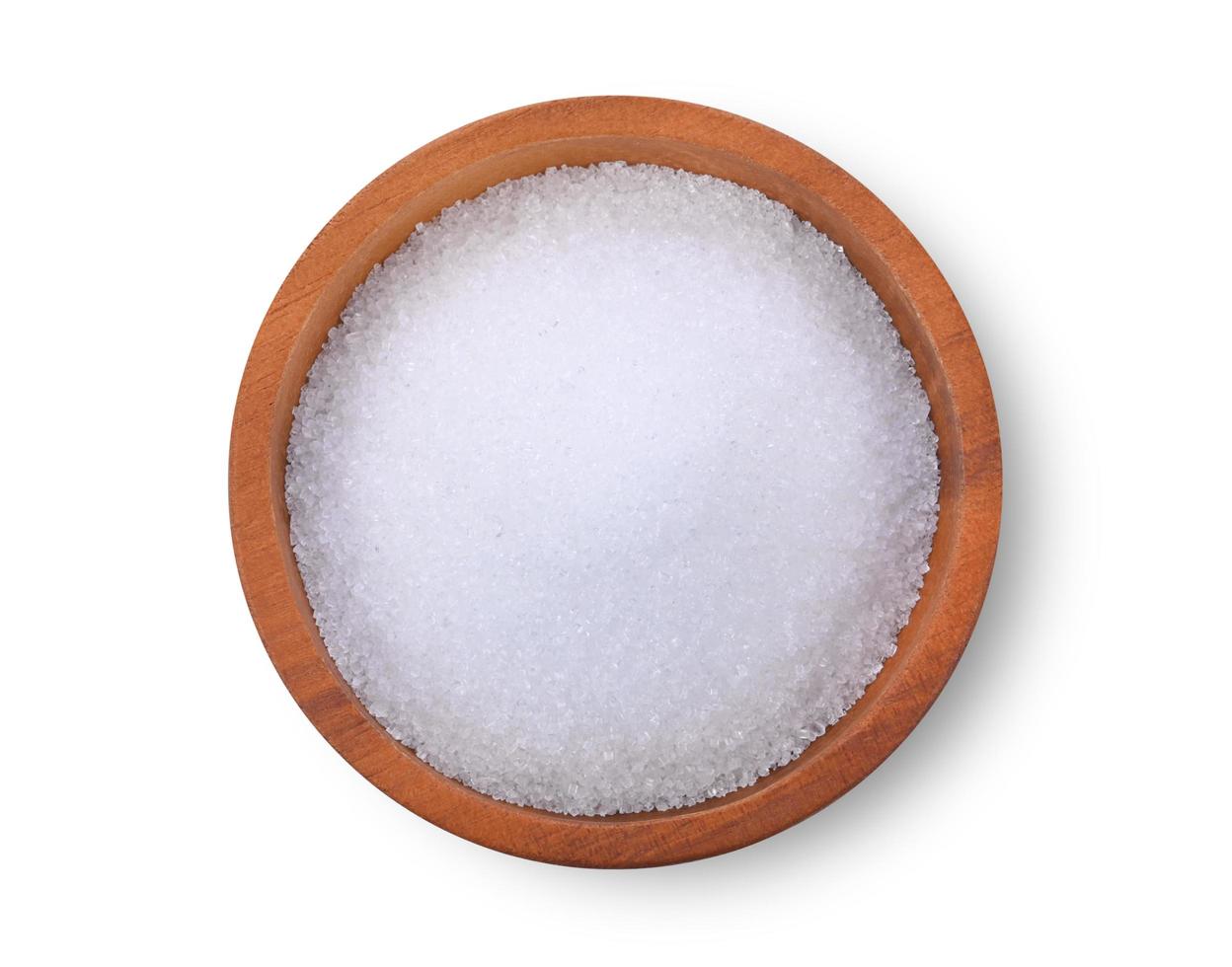 sugar in wooden bowl on white background. Top view photo