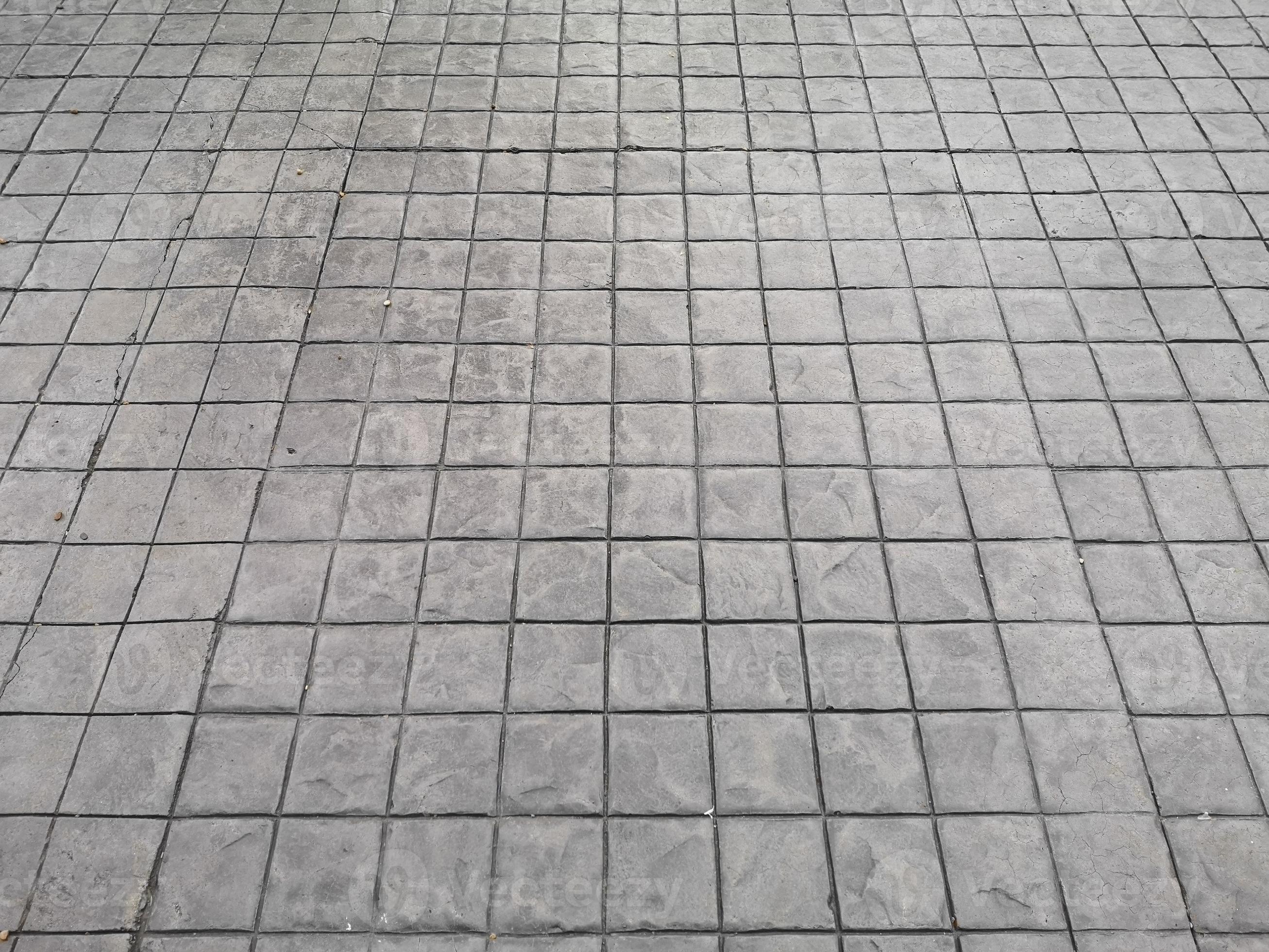 Stamp concrete black color hardener printing patterns on the cement or mortar surface block