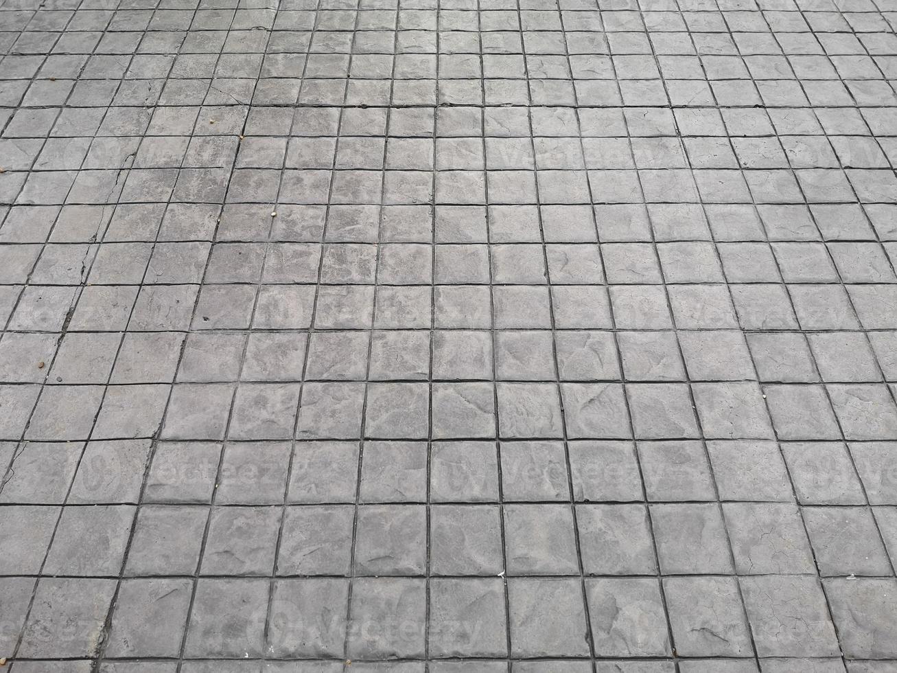 Stamp concrete black color hardener printing patterns on the cement or mortar surface block shape Square pattern material rough texture background photo