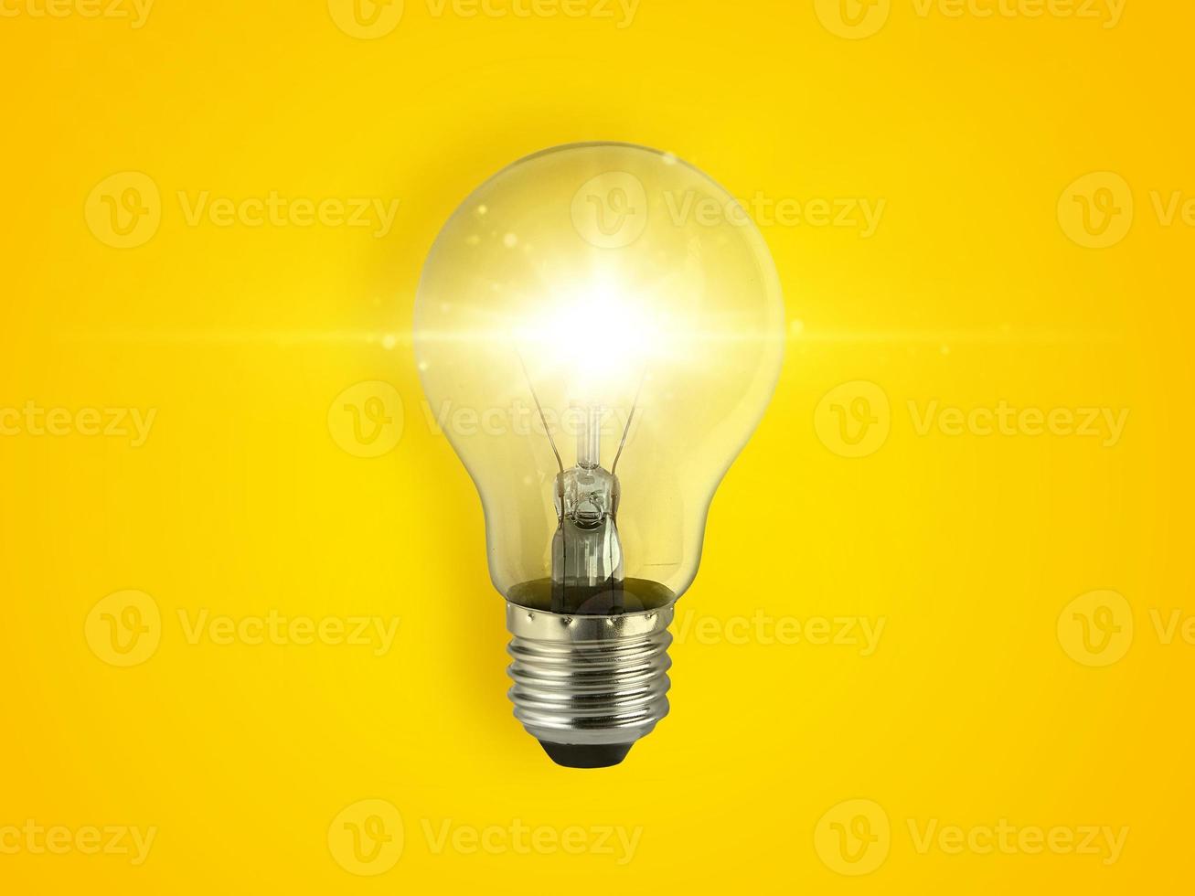 concept creativity with bulbs that shine glitter on yellow background photo