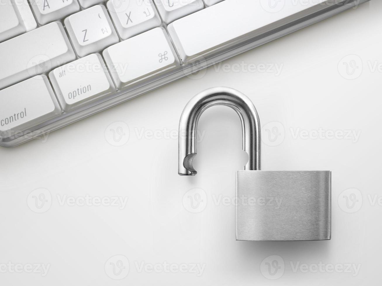 Computer security concept. Unlocked padlock on laptop keyboard. Symbol of safe photo