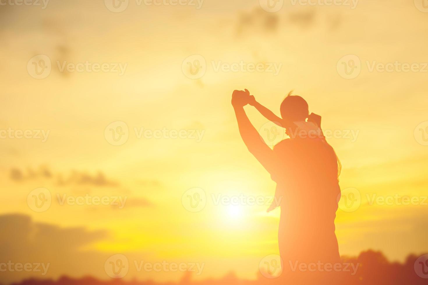 Father took the baby learn to walk at sunset. photo