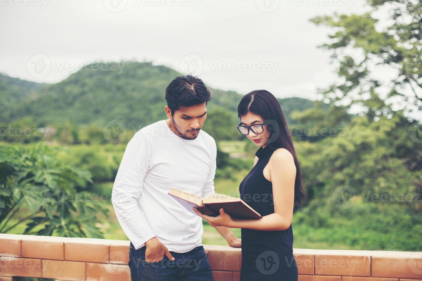 Young education practice together hand typing on laptop and reading book. photo