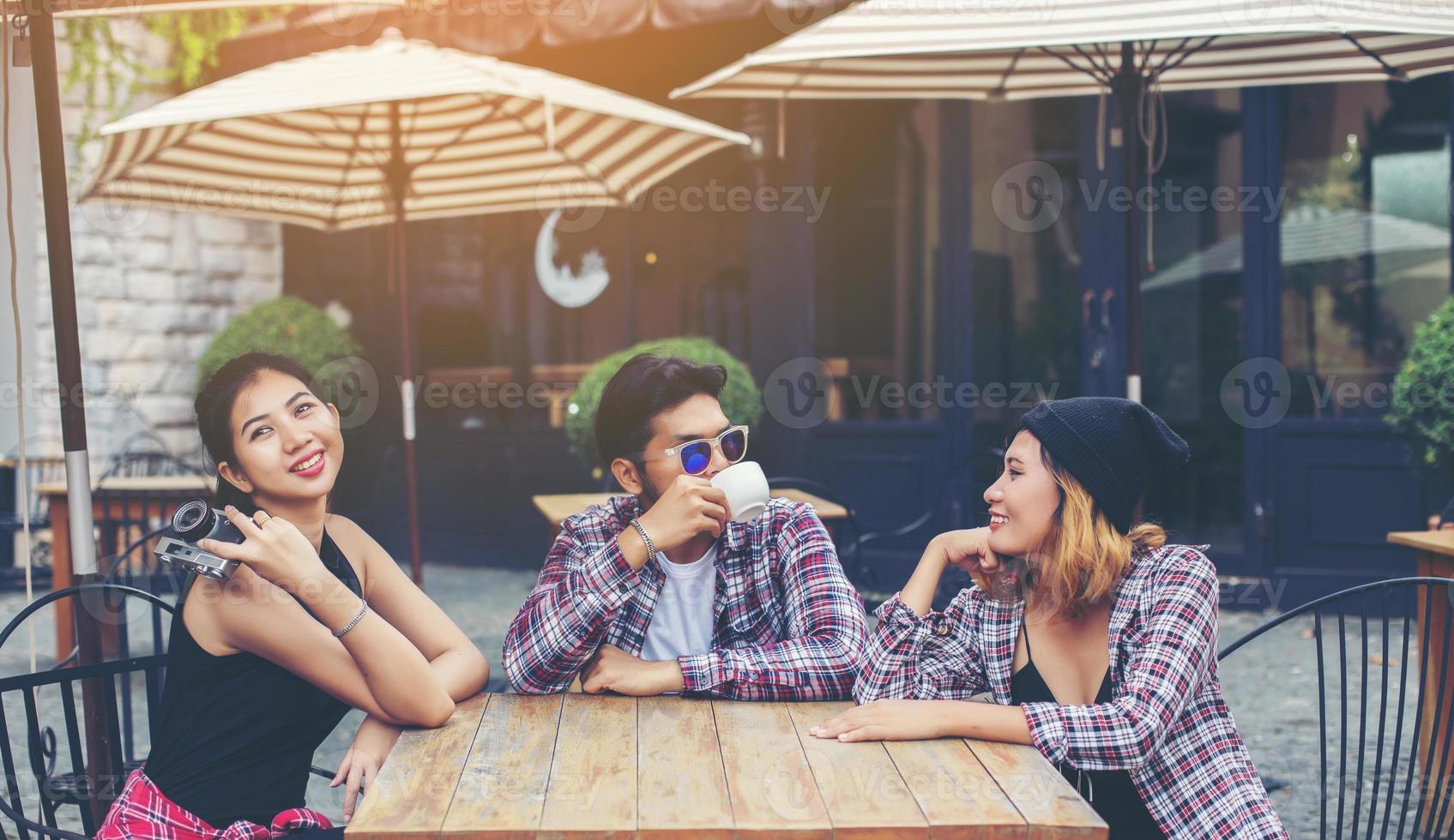 Group of young hipster sitting in a cafe,Young cheerful friends having fun while take time together, Holiday freedom enjoy. photo