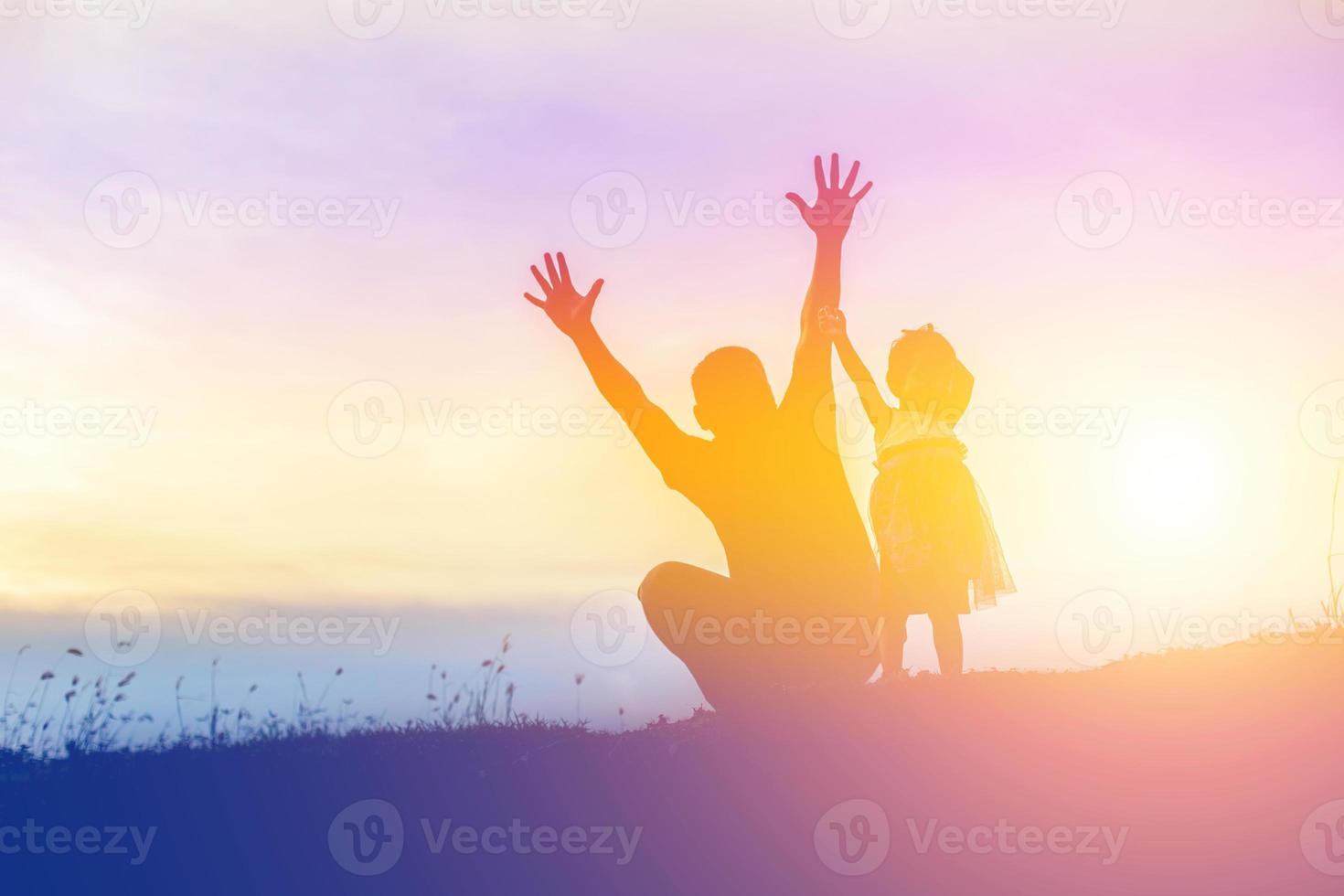 Father took the baby learn to walk at sunset. photo