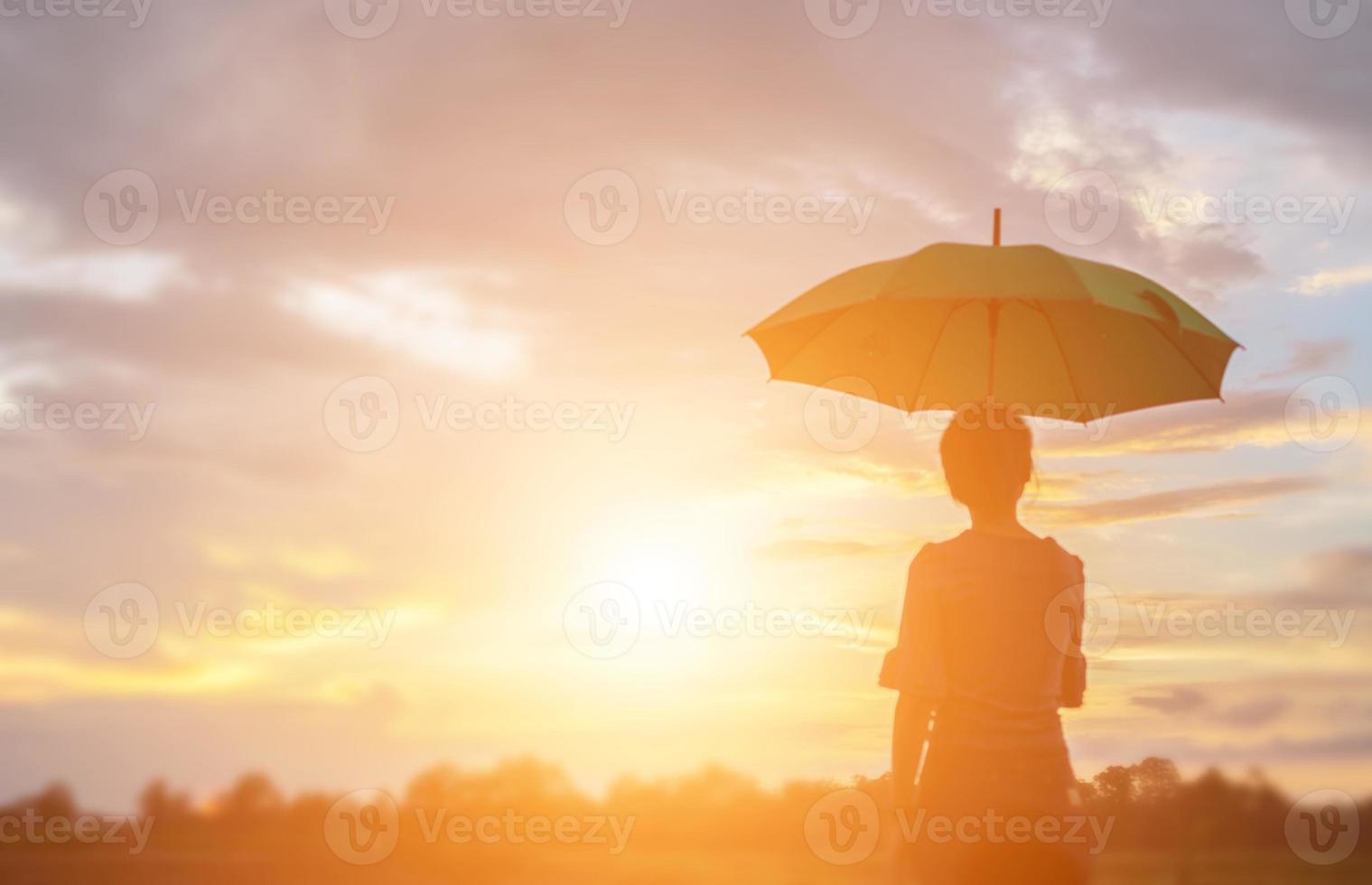 Silhouette of the beautiful girl in the nature at summer sunset. photo