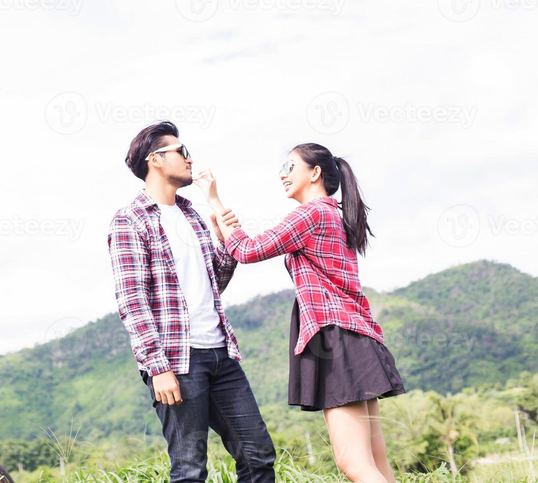 Young hipster couple holding hands walking on the meadow relaxing and natural atmosphere is very natural. photo