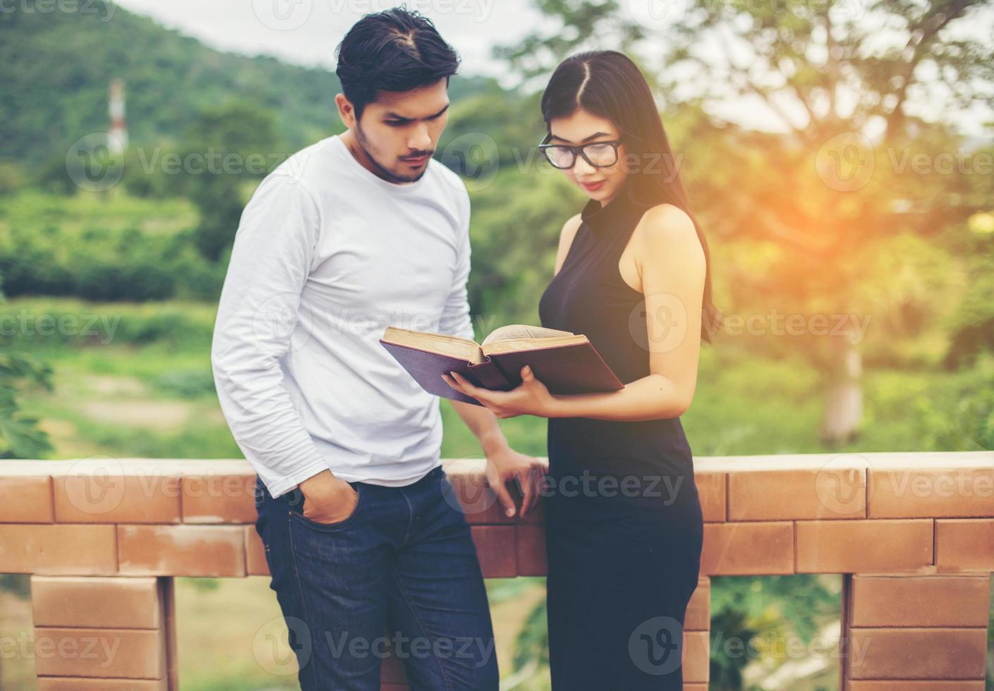 Young education practice together hand typing on laptop and reading book. photo
