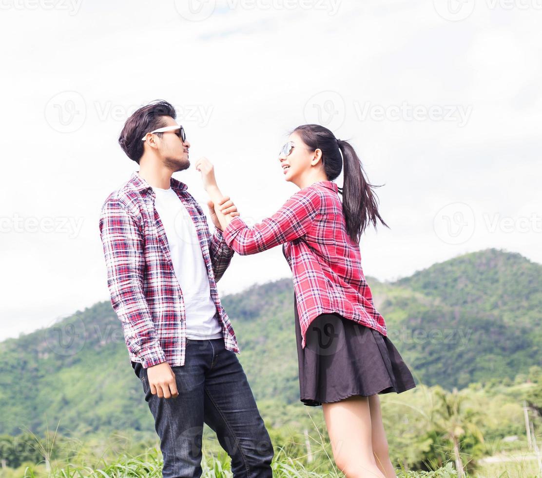 Young hipster couple holding hands walking on the meadow relaxing and natural atmosphere is very natural. photo