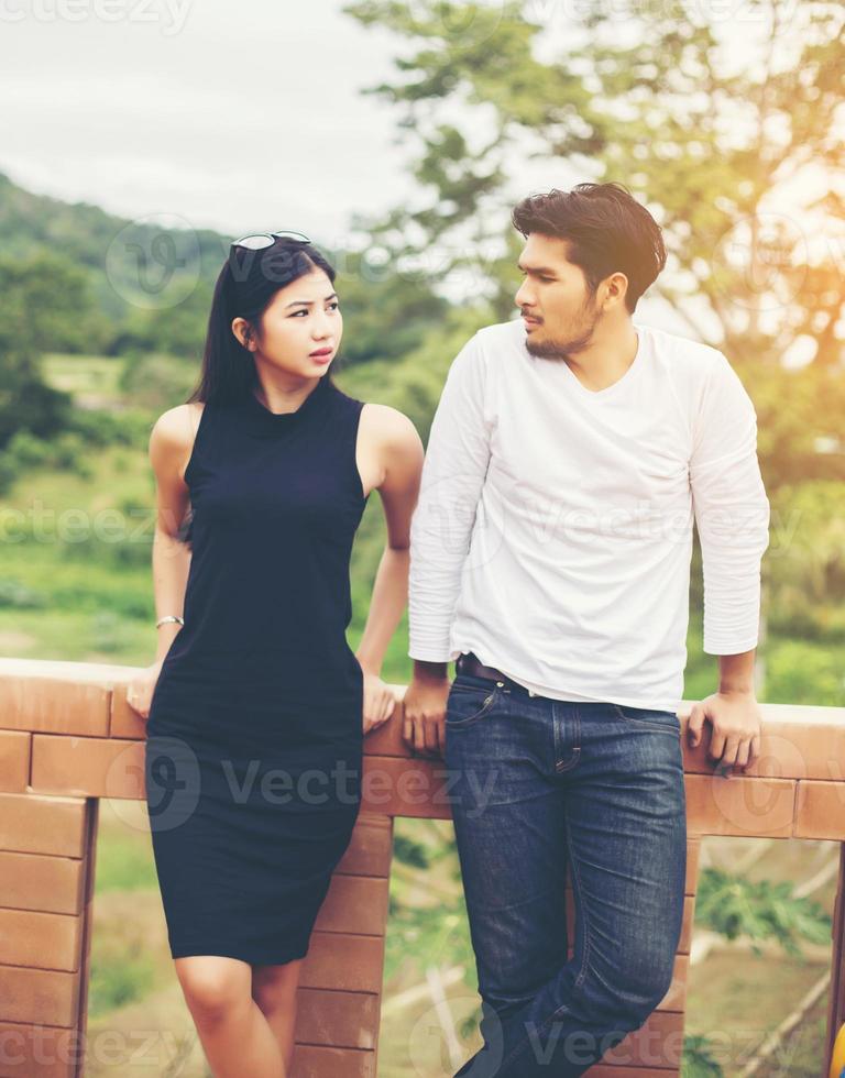 Young handsome boyfriend hugging his girlfriend, she was sad and upset. photo