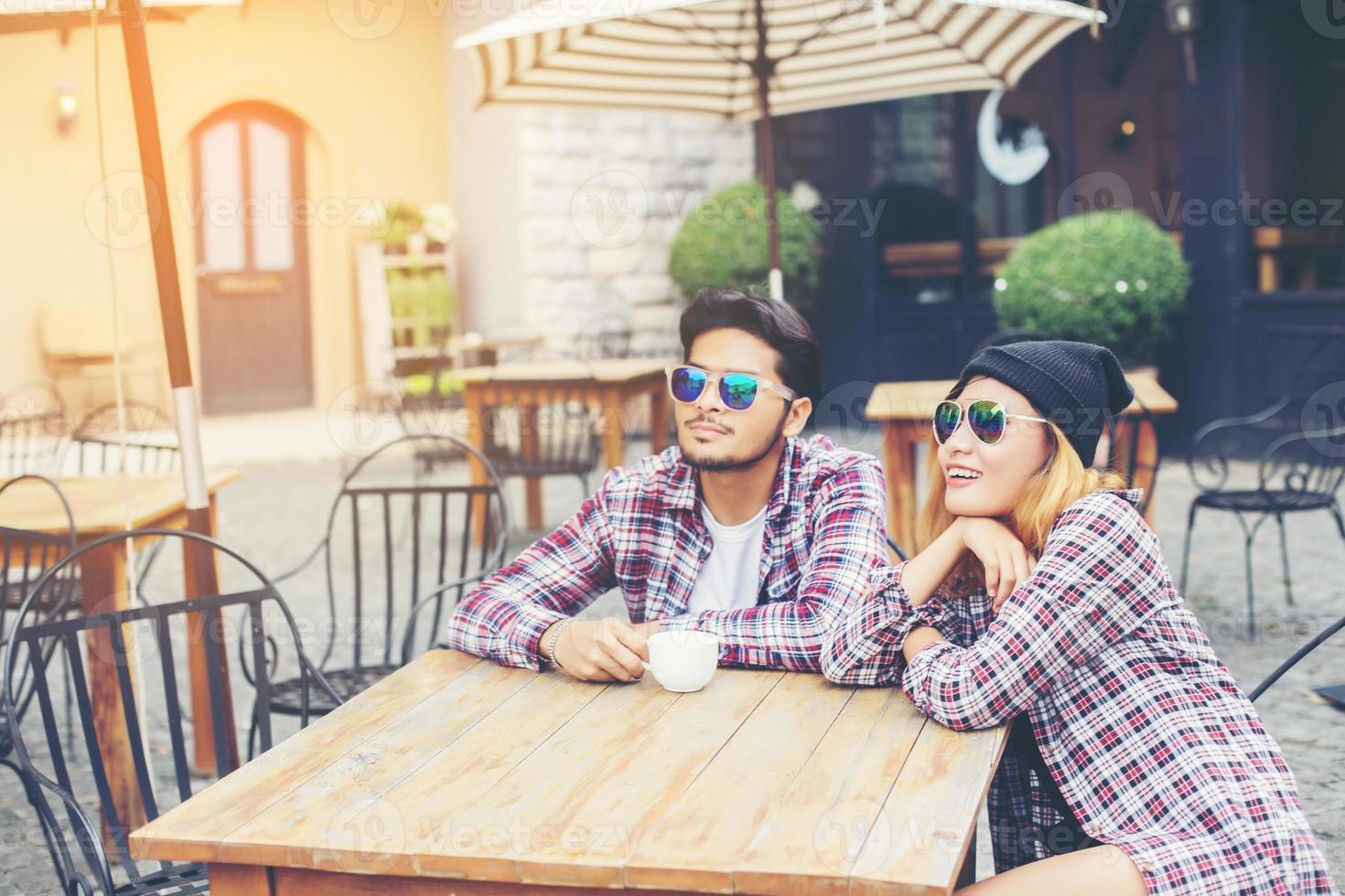 Group of young hipster sitting in a cafe,Young cheerful friends having fun while take time together, Holiday freedom enjoy. photo