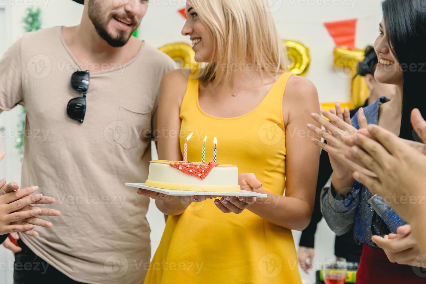 Friend surprise woman with birthday cake and party to beautiful women she very happy and smile. photo
