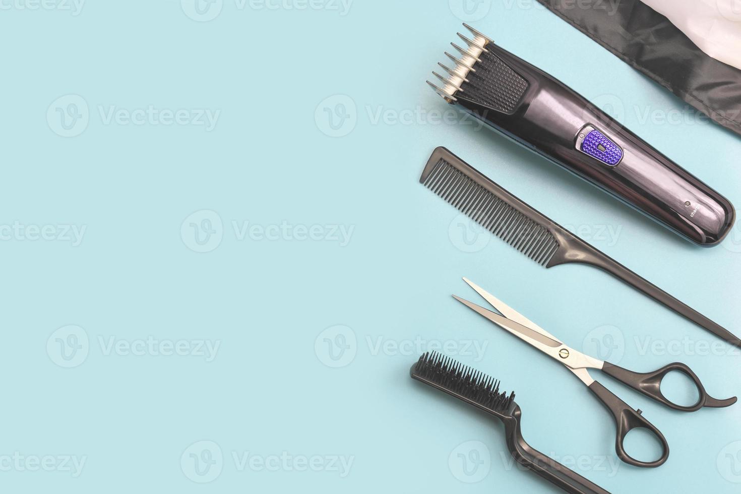 barber's tools on blue background. hair clipper, photo