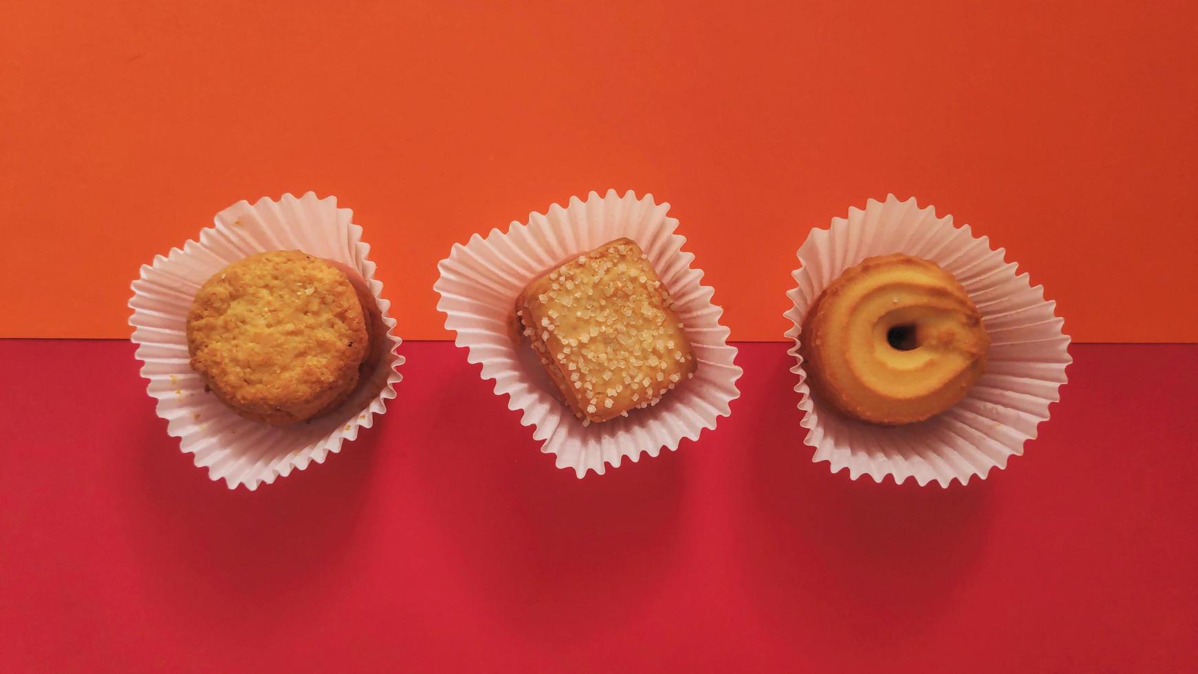 shapes of cookies in stack on red background photo