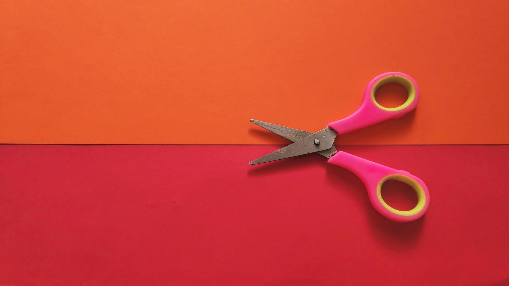 stationery scissors isolated on colored background photo
