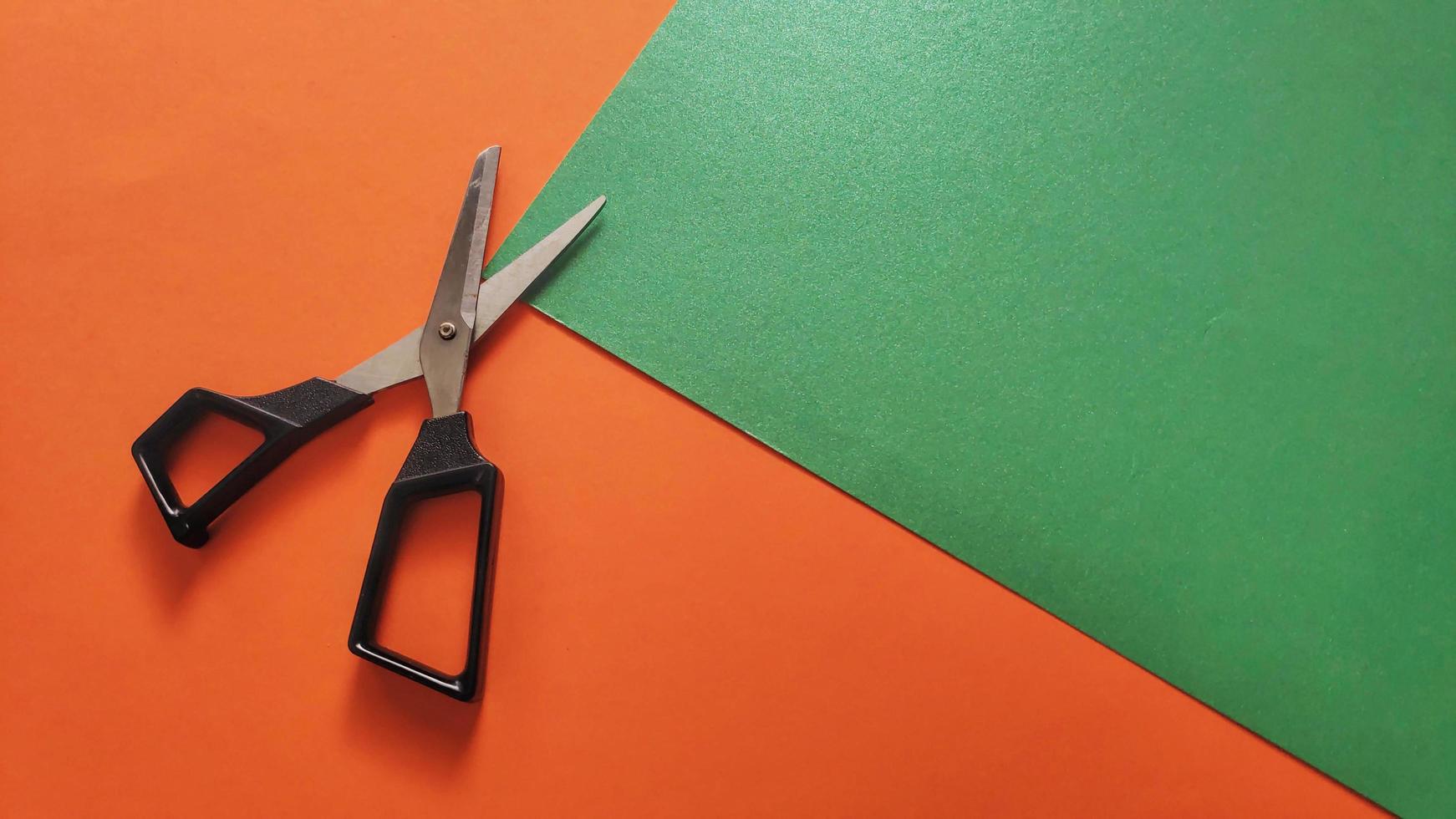 stationery scissors isolated on colored background photo