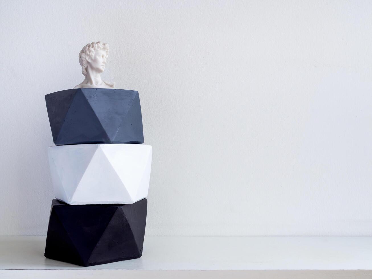 Modern pentagon concrete planters. Painted concrete pots for home decoration photo
