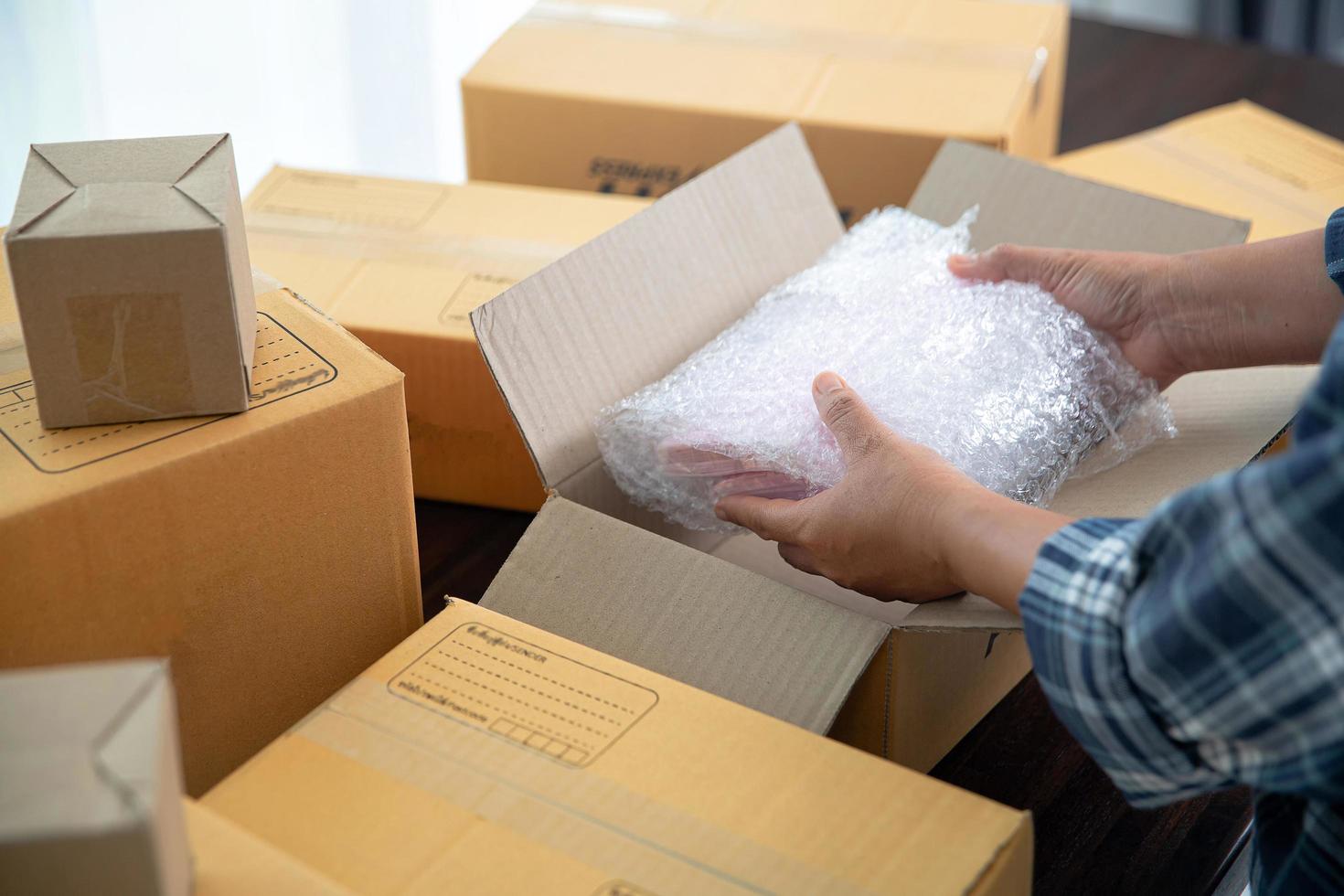 Closeup view of female packing package shipping box photo