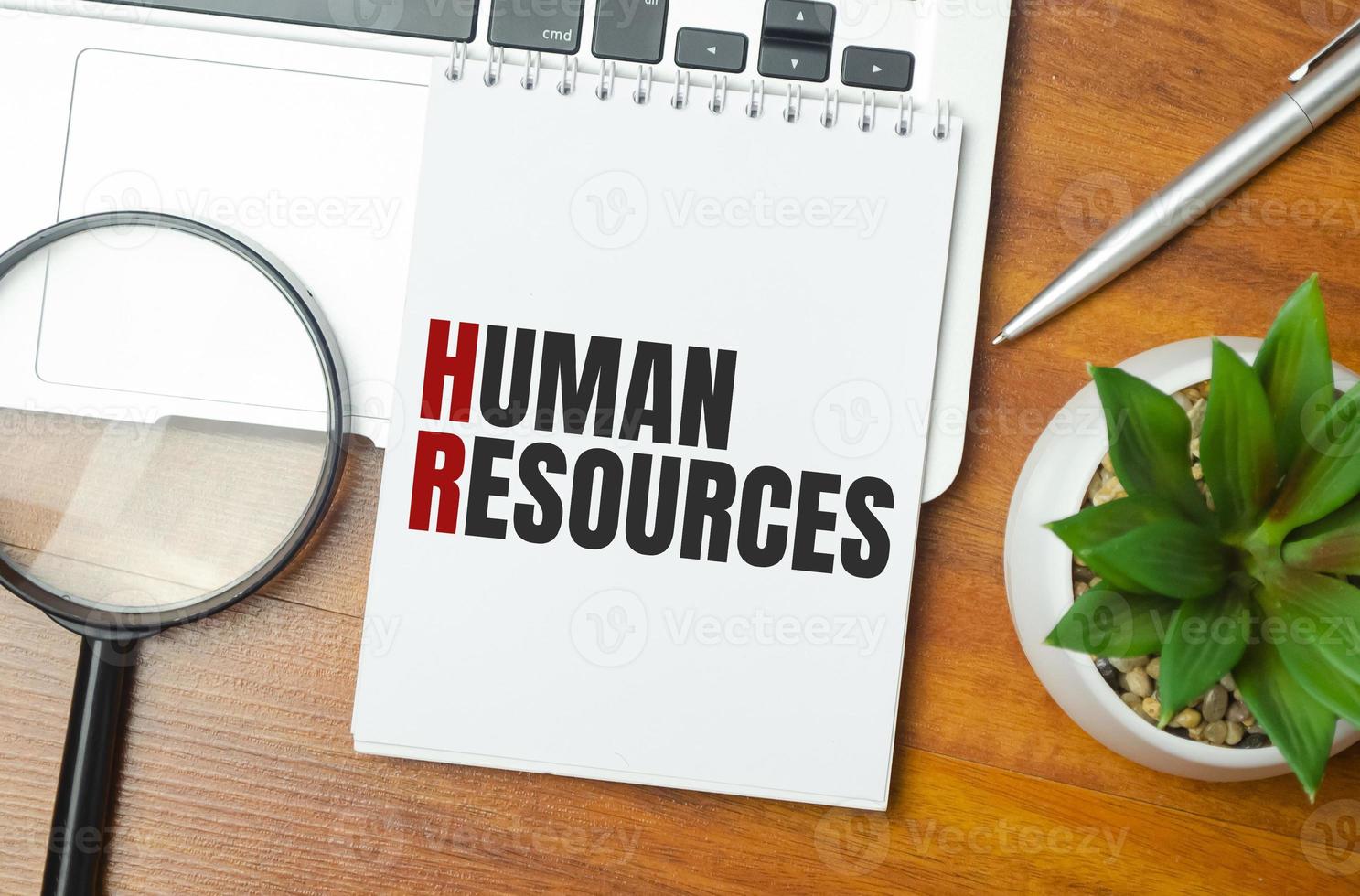human resources . text on white paper and laptop on wooden background photo