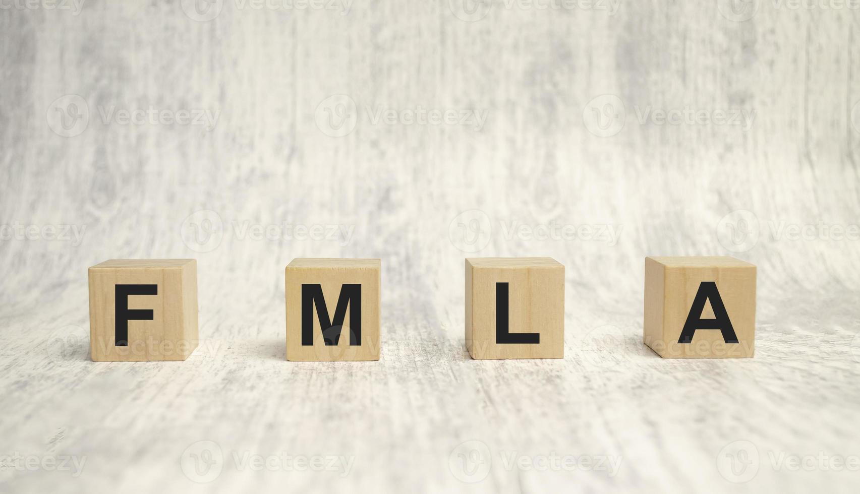 FMLA family medical leave act symbol. Concept words FMLA family medical leave act on wooden cubes photo