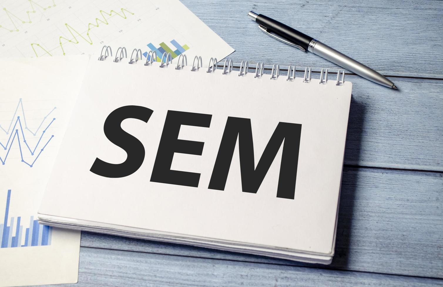 SEM Search Engine Marketing written in notebook on white table photo