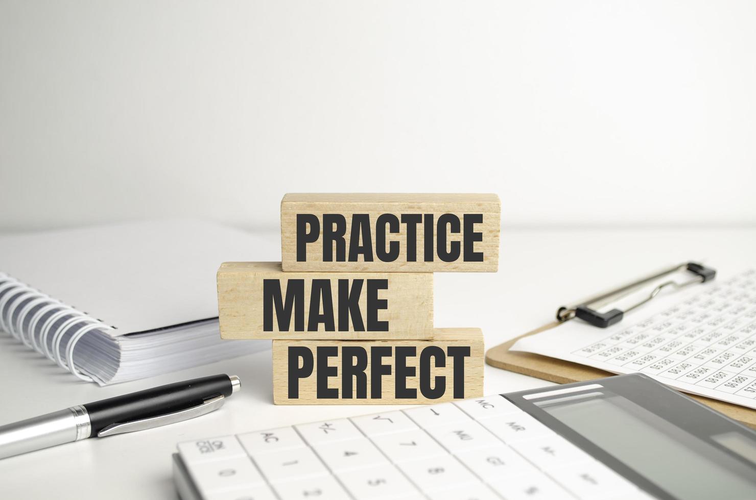 Top view of Practice Makes Perfect words on wooden cube photo