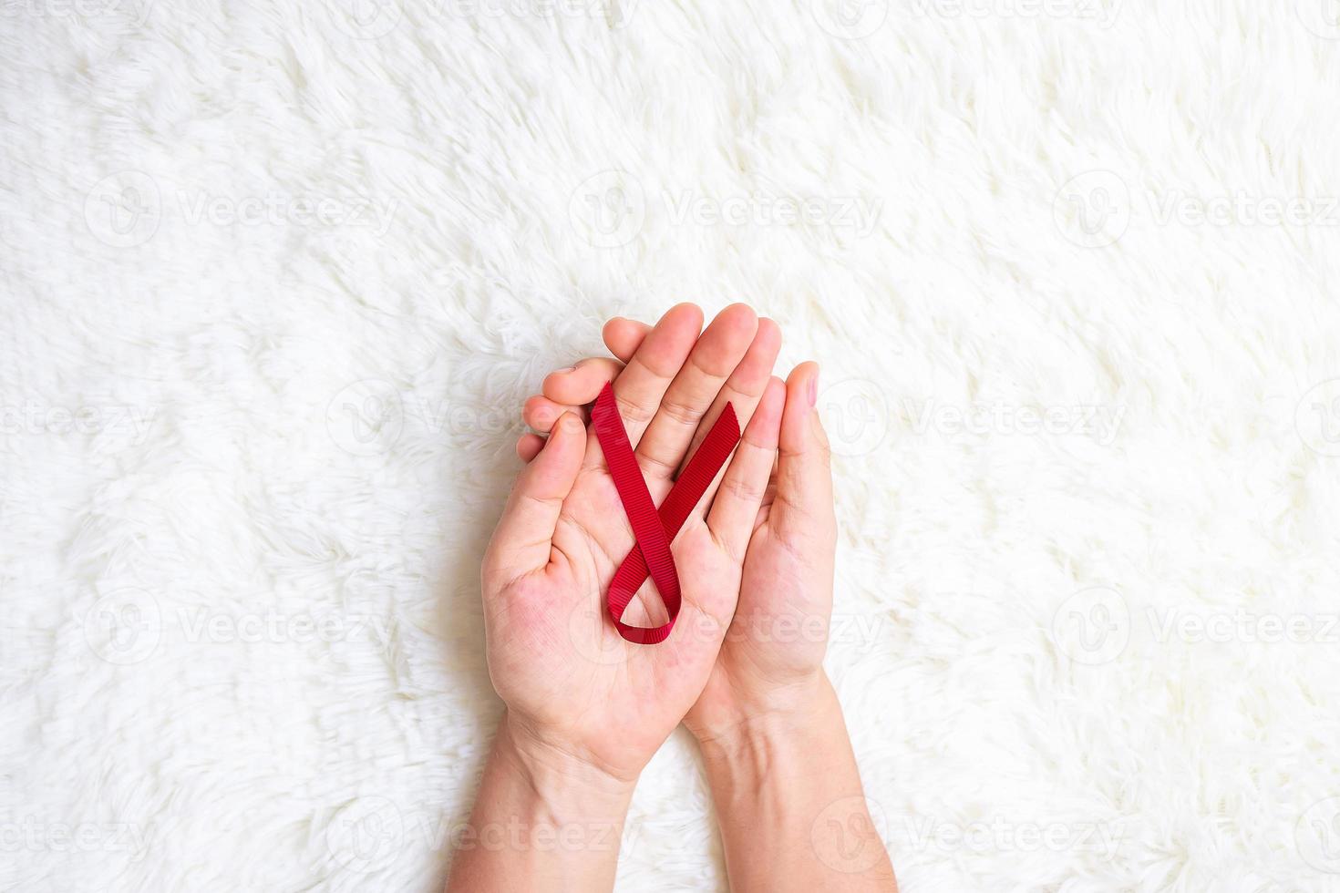 Burgundy Red Ribbon for supporting people living and illness. Healthcare and safe sex concept. December World Aids Day and multiple myeloma Cancer Awareness month photo