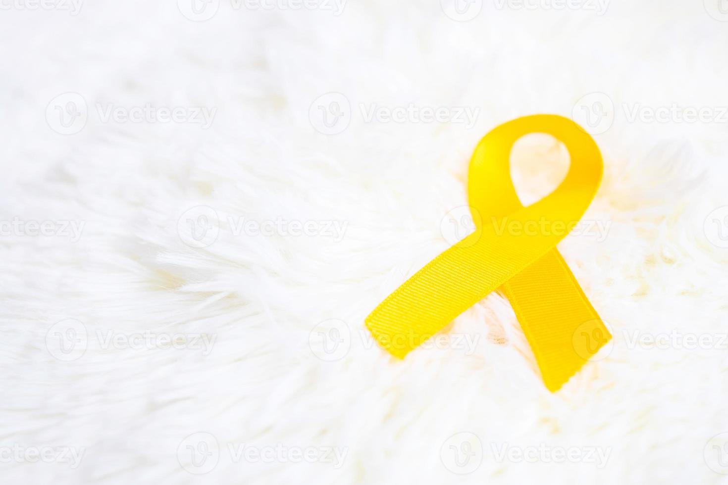 Yellow Ribbon on white background for supporting people living and illness. September Suicide prevention day, Sarcoma cancer and Childhood Cancer Awareness month concept photo