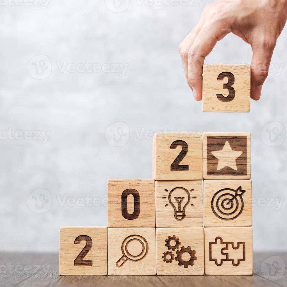 2023 wood block with business success, goal, strategy, target, mission, action, objective, teamwork, plan, idea and New Year start concept photo