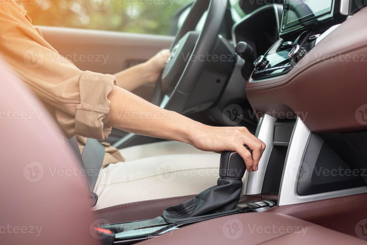 woman driver stick shift transmission a car gear, hand controlling steering wheel during vehicle moving. Journey, trip and safety Transportation concepts photo