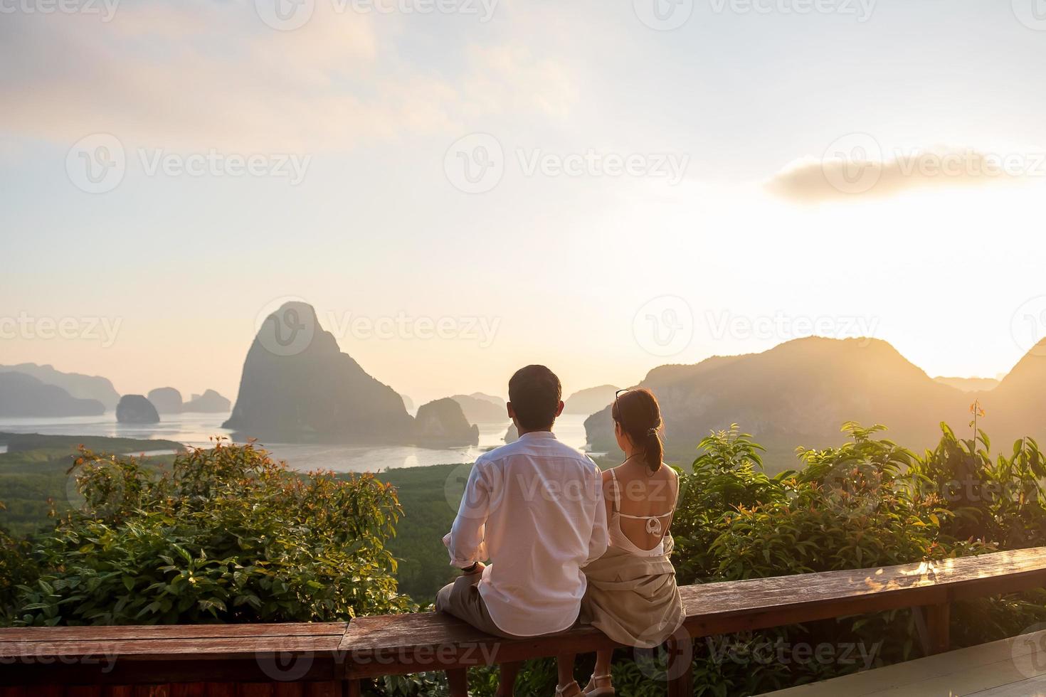 Happy couple traveler enjoy Phang Nga bay view point, Tourists relaxing at Samet Nang She, near Phuket in Southern Thailand. Southeast Asia travel, trip, love, together and summer vacation concept photo