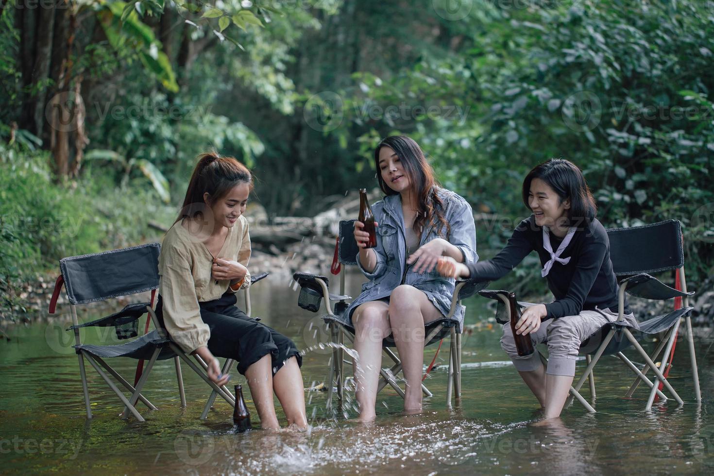 group of Asian girls enjoying a day at the  during holiday camping photo