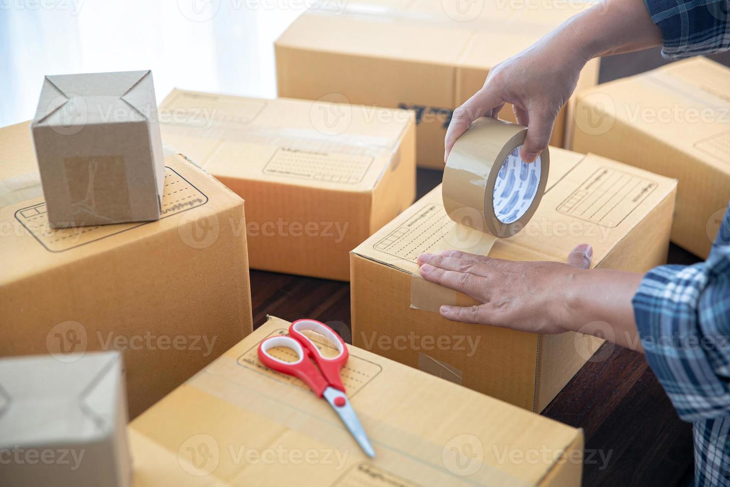 Closeup view of female packing package shipping box photo