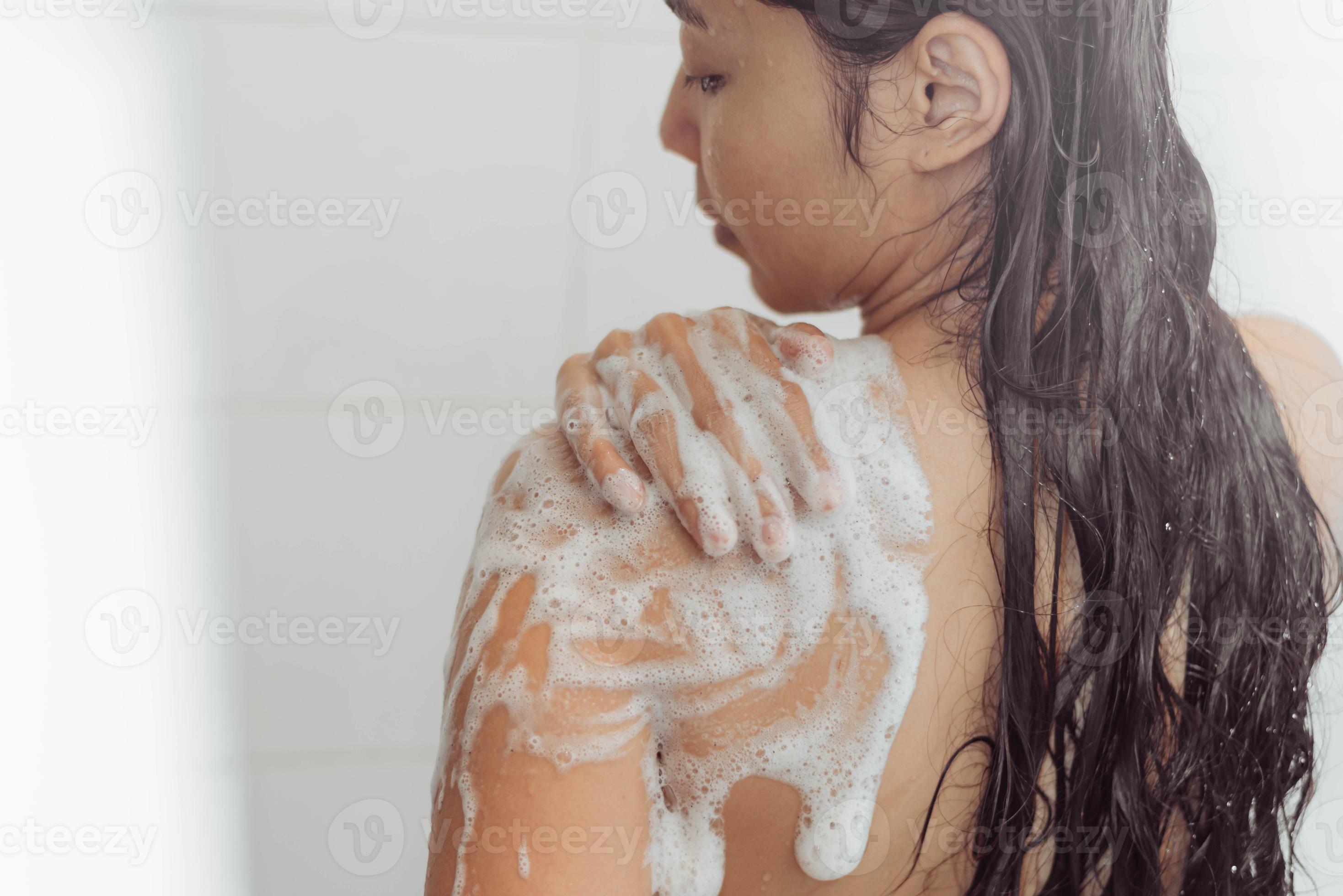 Young woman washing body in shower. Asian woman take a bath in bathroom