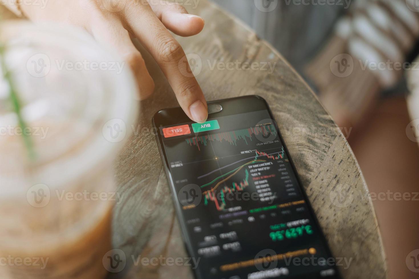 Trader investor discussing and analysis graph on smartphone. business woman using mobile phone app analytics for cryptocurrency. photo