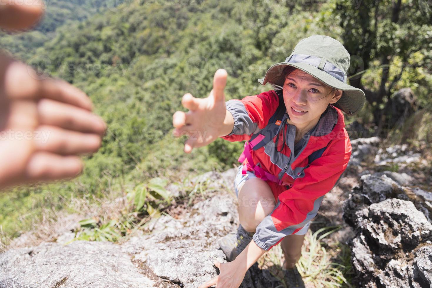 Two people climbing mountain and help, help and assistance concept photo