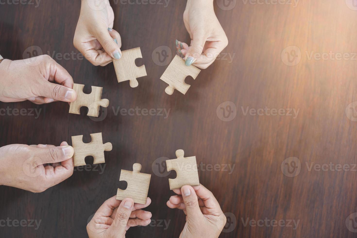 Jigsaw connection, Jigsaw puzzle in the hand of a businessman,  Business team assembling Jigsaw puzzle. photo