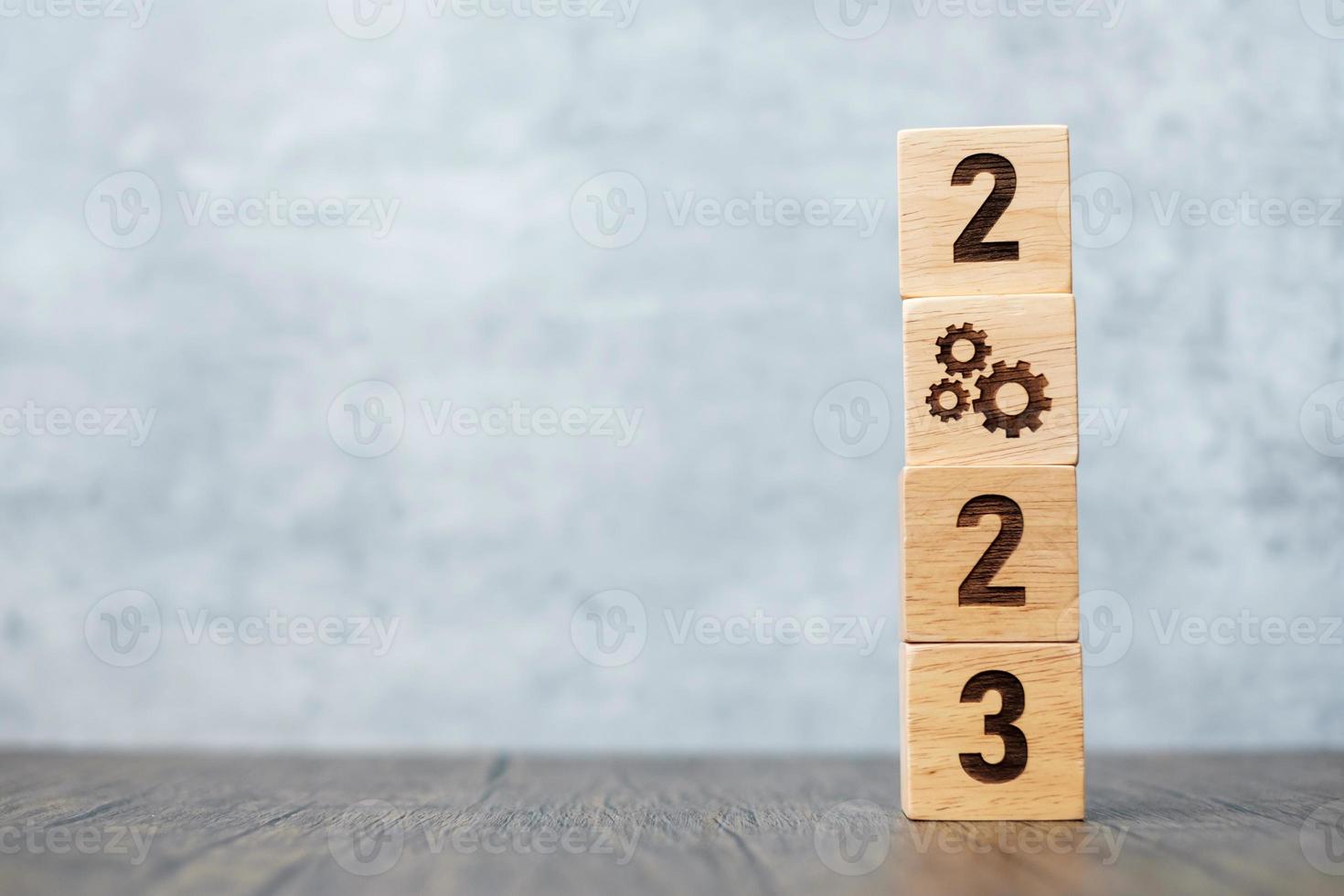 2023 block with gear icon. Business Process, Team, teamwork, Goal, Target, Resolution, strategy, plan, Action, motivation, change, brainstorm and New Year start concepts photo