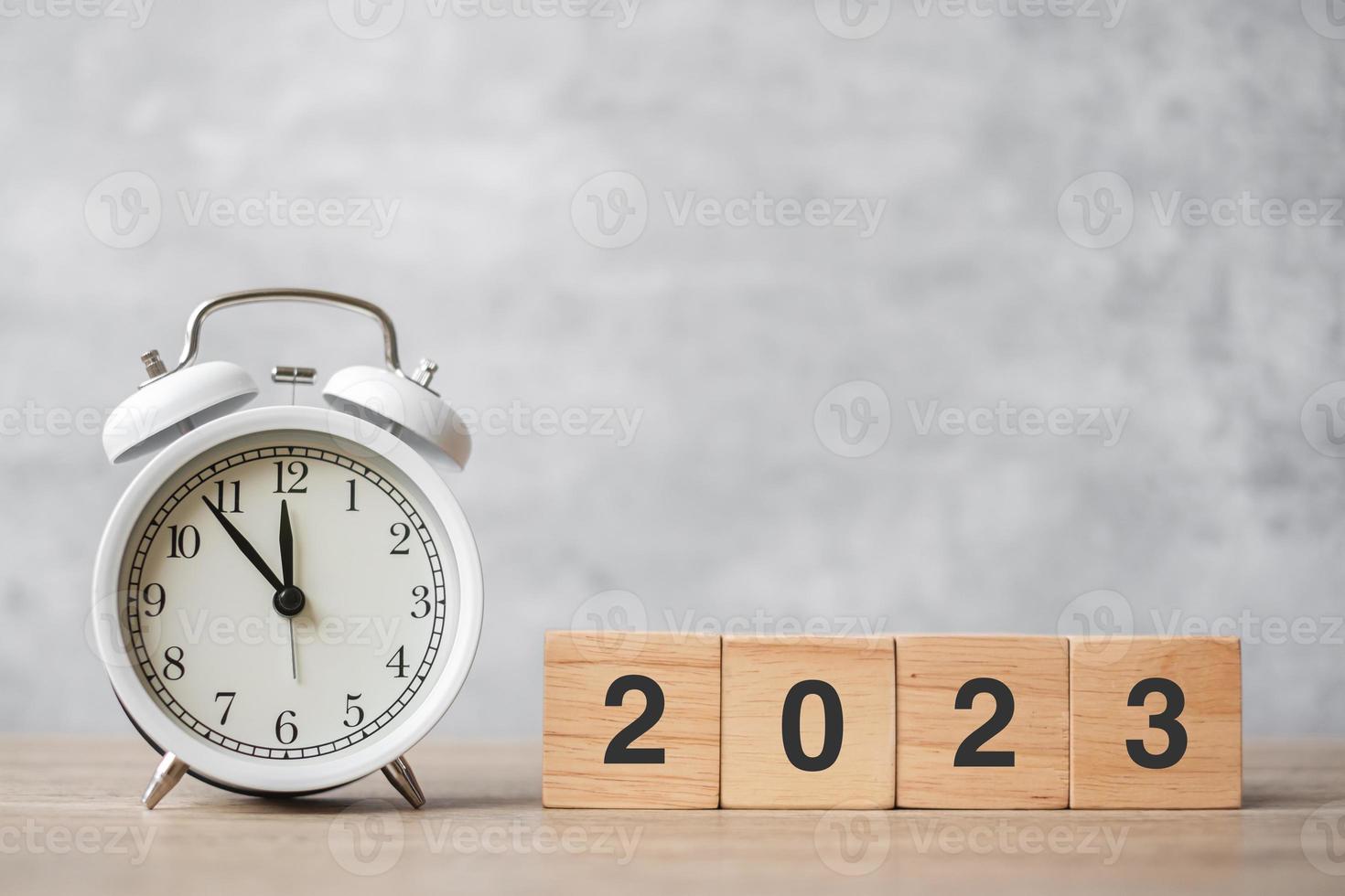 Happy New Year with vintage alarm clock and 2023 block. Christmas, New Start, Resolution, countdown, Goals, Plan, Action and Motivation Concept photo