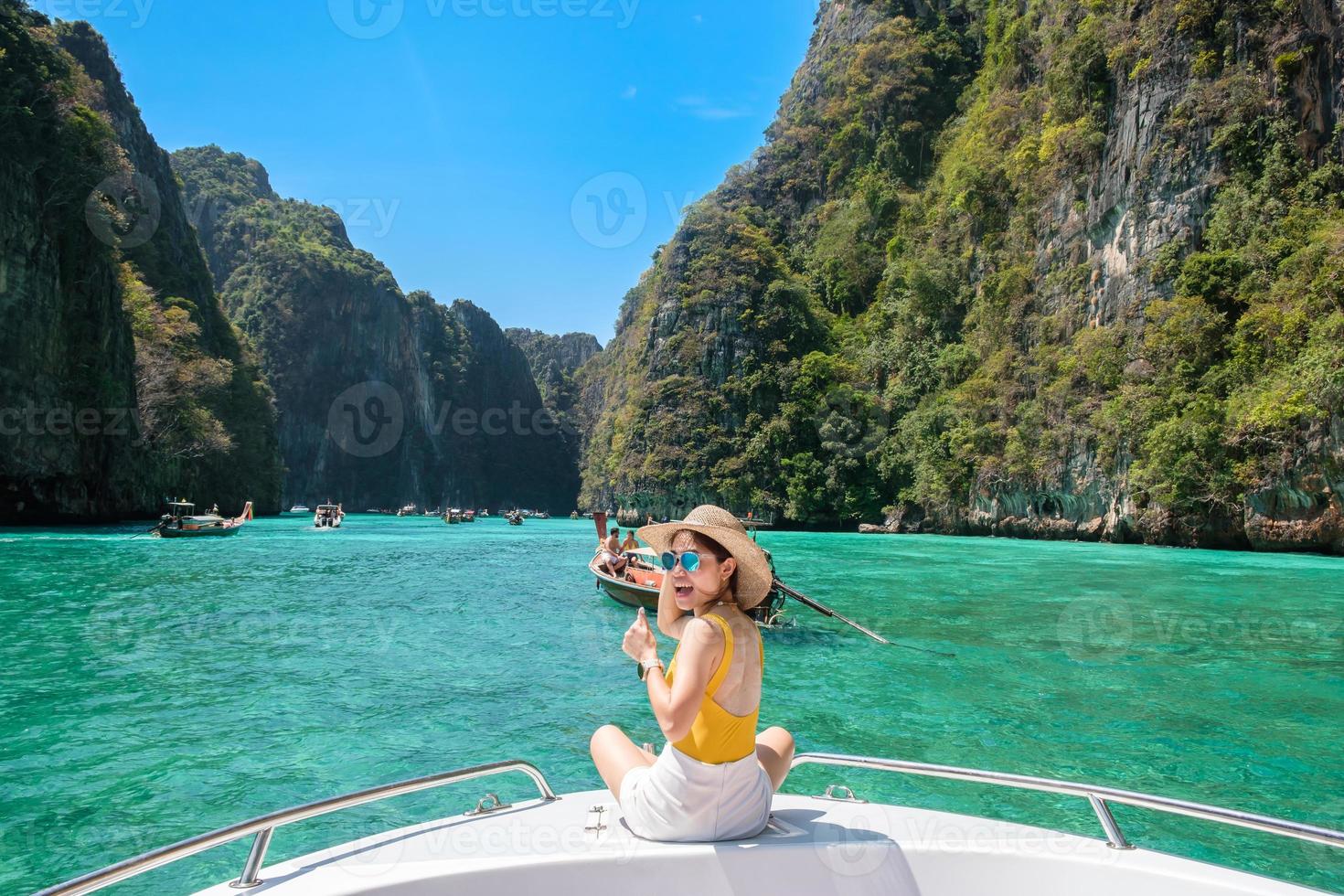 Woman tourist on boat trip, happy traveller relaxing at Pileh lagoon on Phi Phi island, Krabi, Thailand. Exotic landmark, destination Southeast Asia Travel, vacation and holiday concept photo