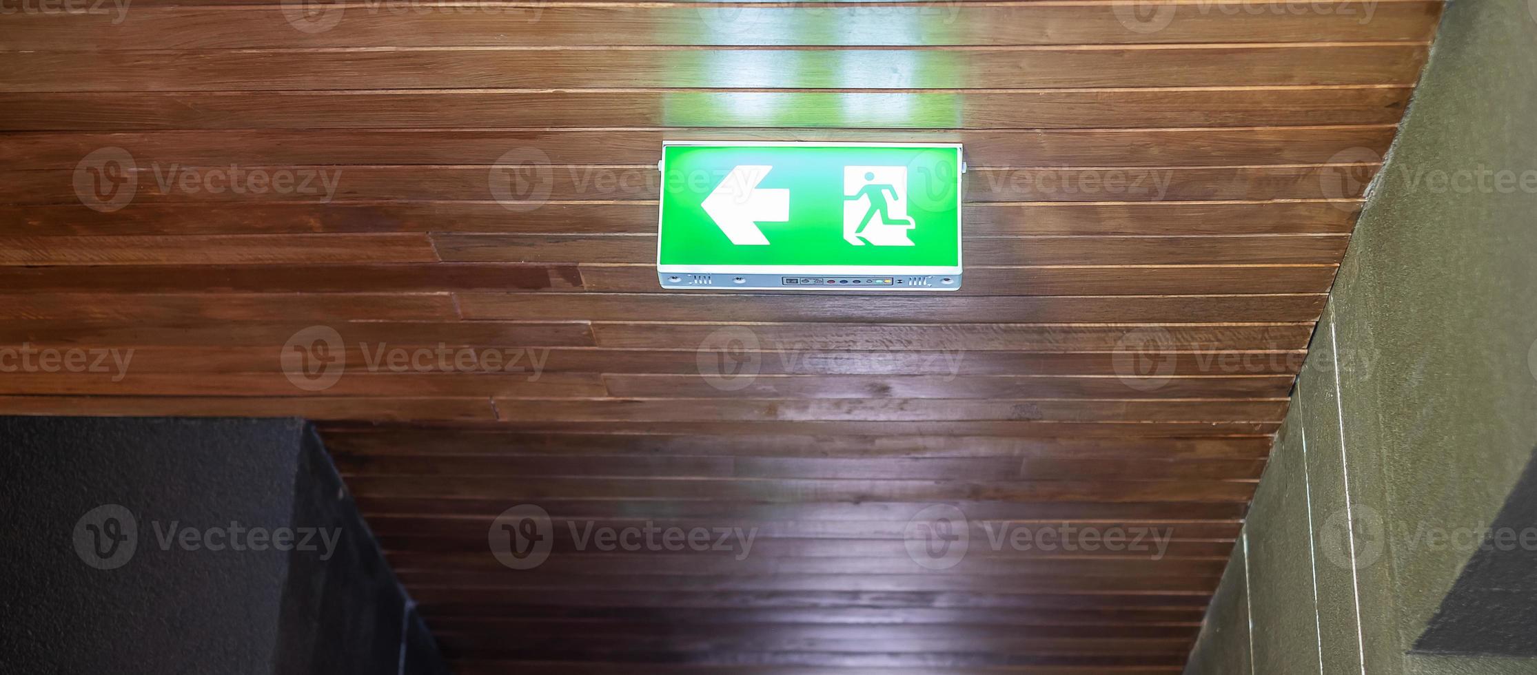 Fire Emergency exit sign on the wall background inside building. Safety concept photo