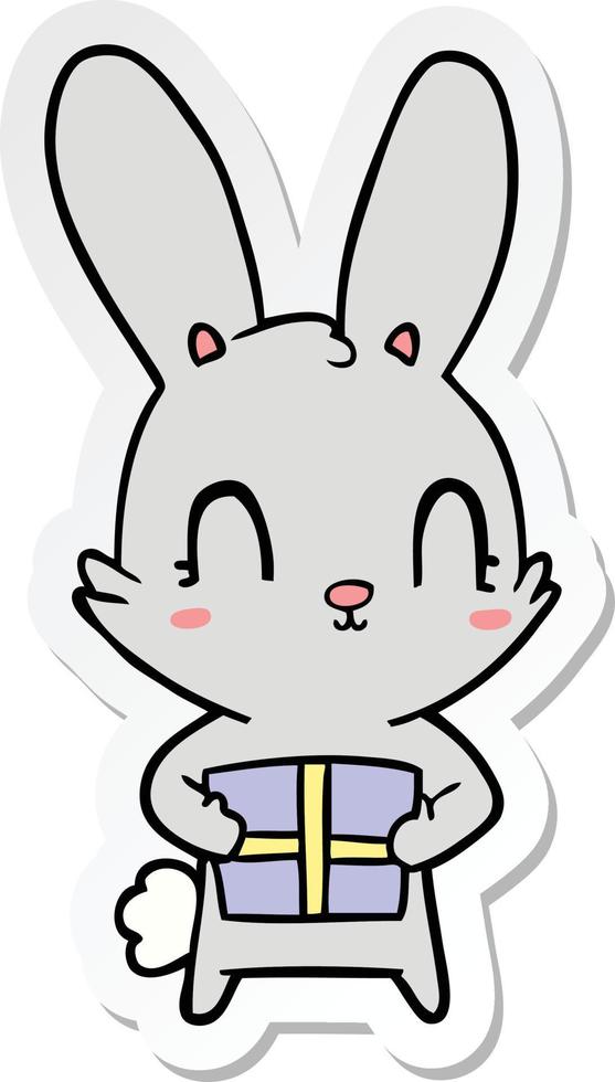 sticker of a cute cartoon rabbit with present vector