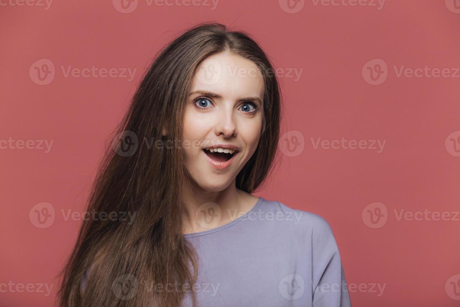 Amazed Satisfied Beautiful Female Model With Dark Straight Hair Keeps Mouth Opened Hears Unexpected News Poses Against Pink Studio Background People Emotions Facial Expressions Feelings Concept Stock Photo At Vecteezy