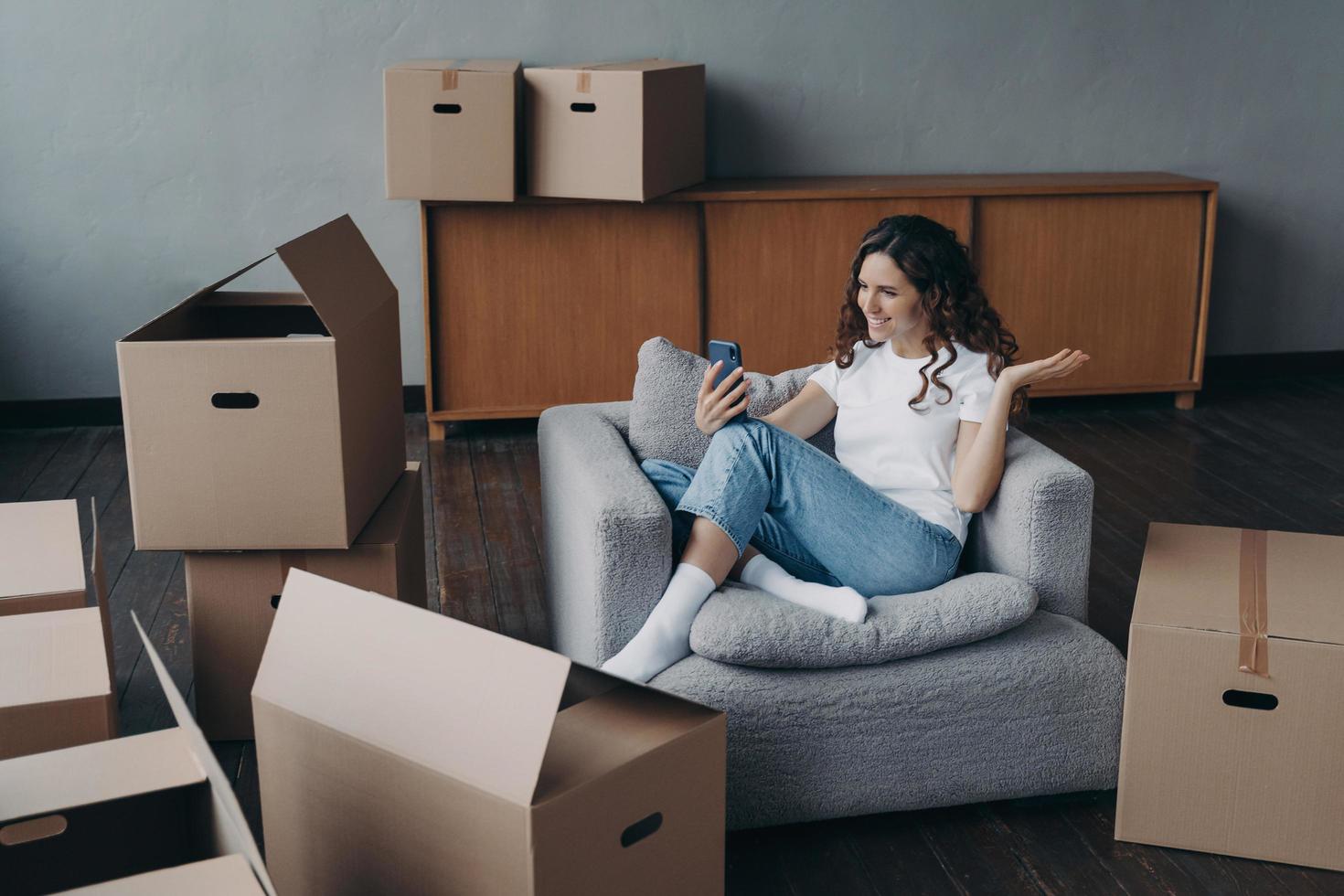 Happy girl having video call on phone showing her dream house. Mortgage loan concept. photo