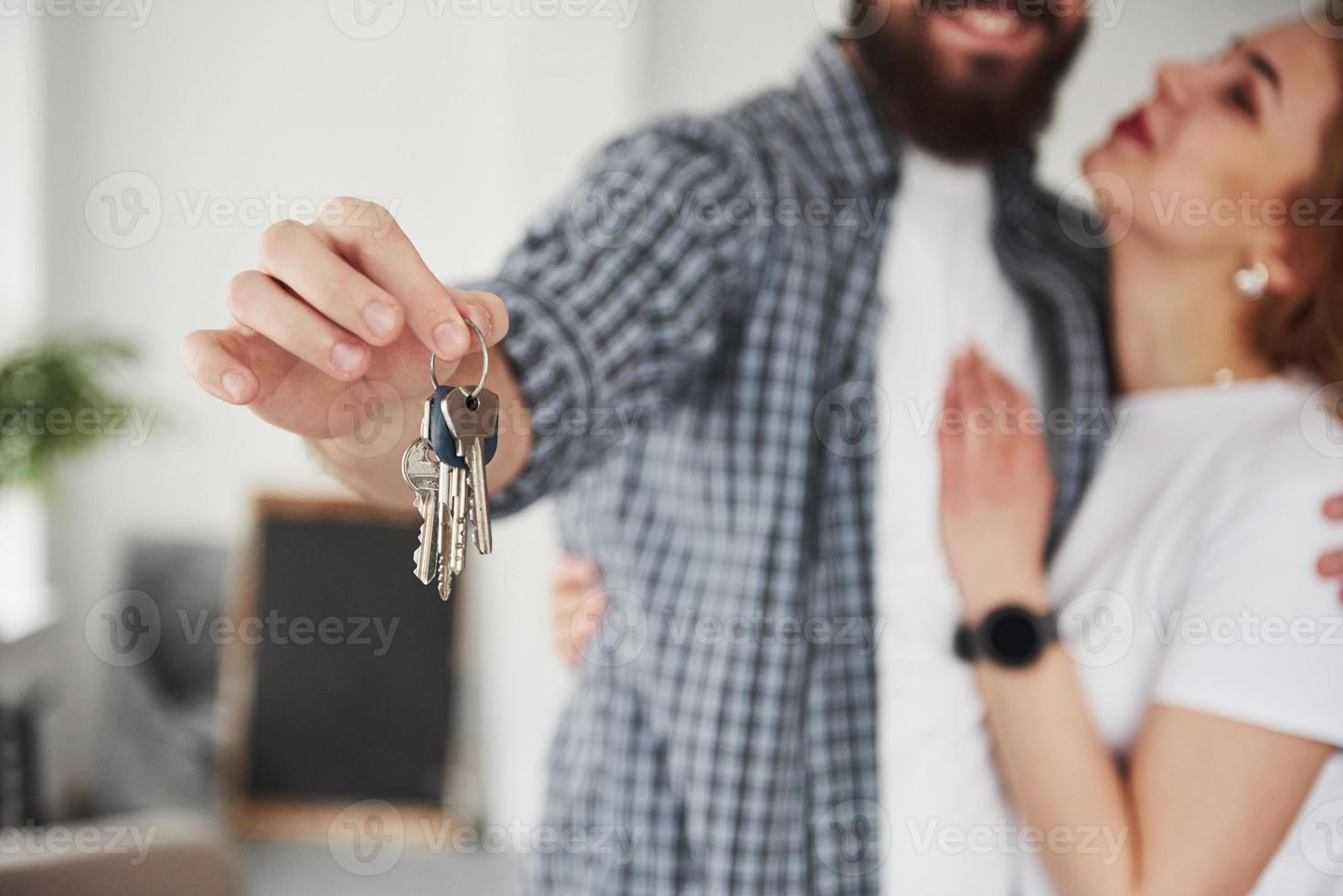 Dream come true. Happy couple together in their new house. Conception of moving photo