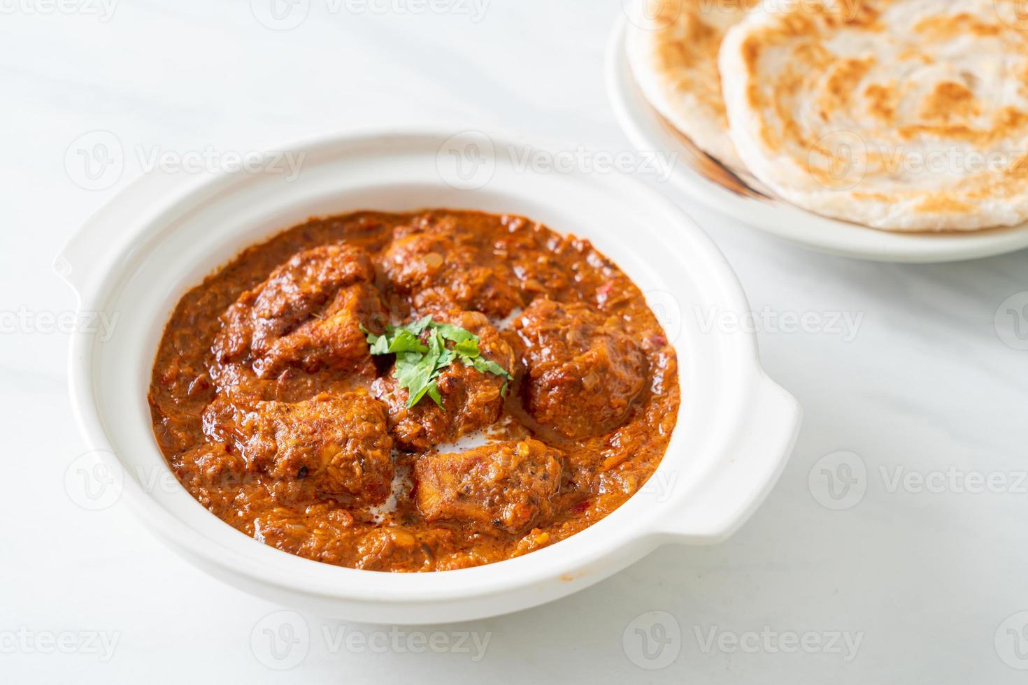 chicken tikka masala spicy curry meat food with roti or naan bread photo