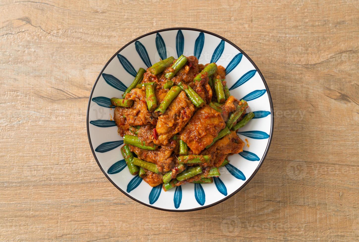 Stir fried pork with red curry paste photo