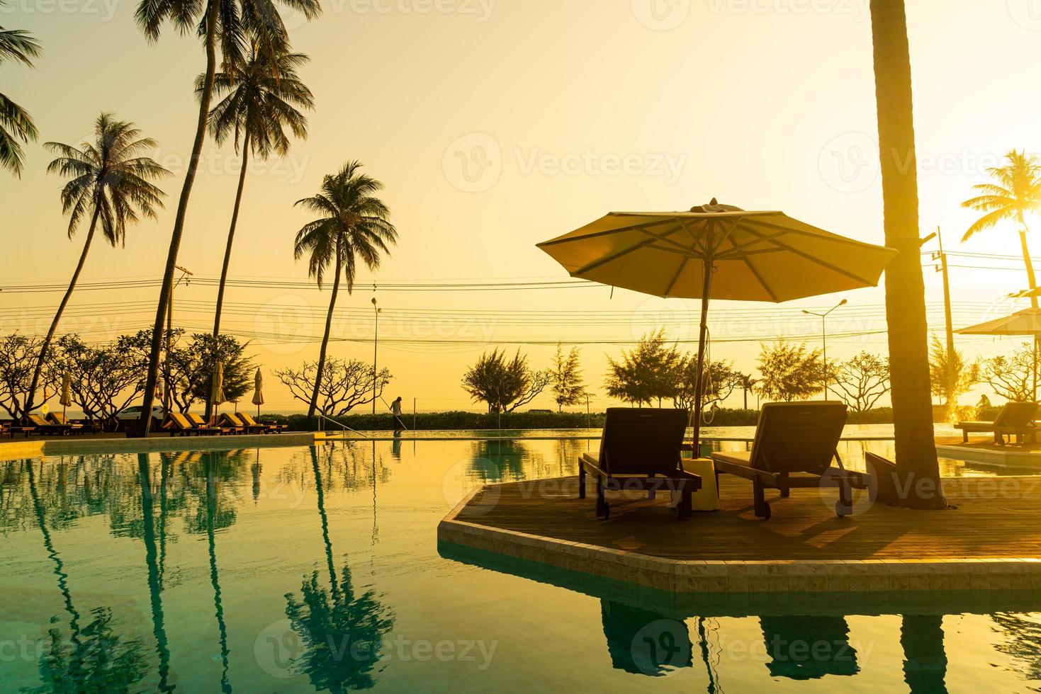 umbrella with bed pool around swimming pool with ocean sea background
